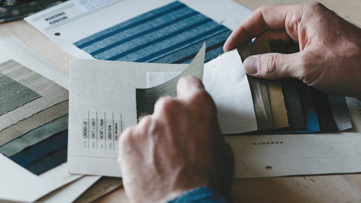 Bridge & Burn founder Erik Prowell looking through fabric swatches