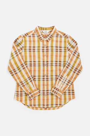 The Bridge & Burn Ash Slim Shirt in Heceta Plaid features a slim fit, long sleeves, collar, and a button-up front with an orange, yellow, brown, and white plaid pattern, displayed flat on a white background.