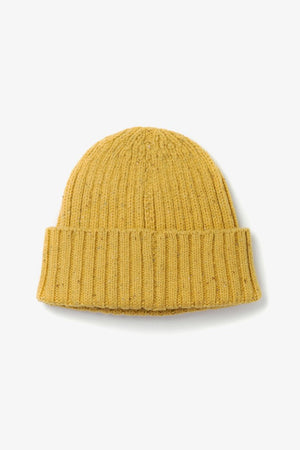 The Chunky Ribbed Beanie in Goldenrod by Bridge & Burn features a folded brim and is crafted from extrafine merino wool, shown against a plain white background.