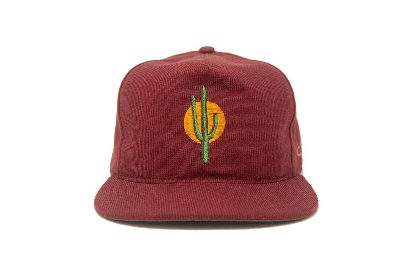 The Ampal Creative - Sunset Cactus / Brick is a maroon cotton Bedford cloth hat made in Los Angeles, featuring an embroidered green cactus and yellow-orange sun on the front, shown against a white background.