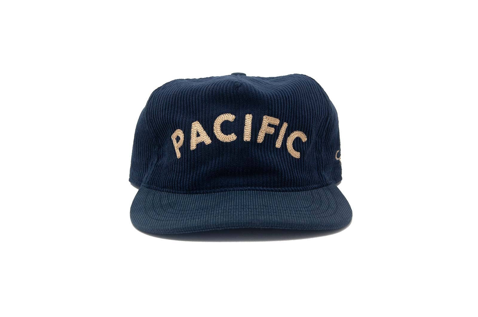 The Ampal Creative - Pacific III Strapback in navy features vintage-style beige "PACIFIC" embroidery on the front, showcased against a plain white background.