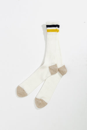 A pair of RoToTo Rototo OS Ribbed Crew Socks in navy with yellow and black striped ribbed cuffs are laid out on a plain white background.