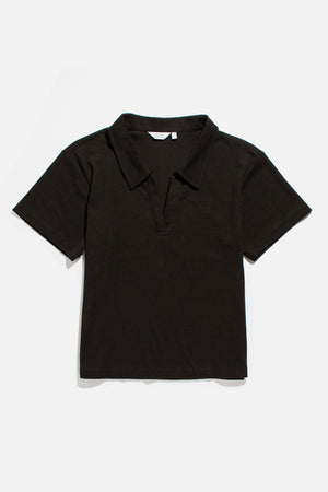 The Avery Boxy Top by Bridge & Burn is a short-sleeved, black jersey shirt with a boxy fit, collar, and V-neck opening, shown laid flat on a plain white background.