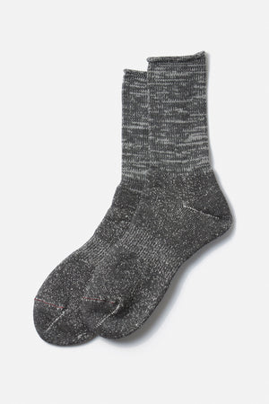 The RoToTo Washi Pile Crew Socks in Charcoal, inspired by traditional Japanese paper yarn socks and crafted in Japan, feature a textured knit pattern and are shown on a plain white background.