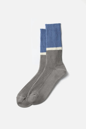 RoToTo Bicolor Ribbed Socks in Light Blue Grey, made in Japan, feature ribbed crew styling with grey feet and ankles, a white mid-calf stripe, and light blue tops. Displayed on a plain white background.