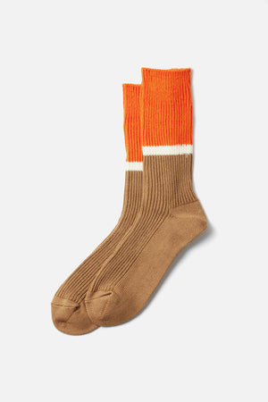 RoToTo Bicolor Ribbed Socks in Orange Light Brown feature ribbed tan feet and ankles, a white stripe, and bright orange calves. Made from organic cotton, these socks are shown laid flat on a white background.