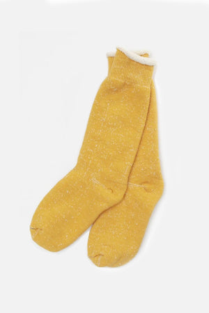 A pair of RoToTo Double Face Crew Socks in yellow by RoToTo, made from cozy organic cotton with rolled cuffs, shown laid flat on a white background.