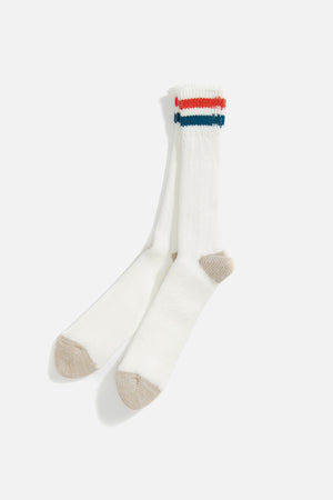 RoToTo Rototo OS Ribbed Crew Socks in white organic cotton, featuring beige toes and heels plus red, navy blue, and teal stripes near the cuffs, are displayed on a white background.