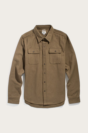 The Bridge & Burn Bedford Shirt in olive twill is a long-sleeved cotton button-up with a collar and two chest pockets, shown laid flat on a light background.