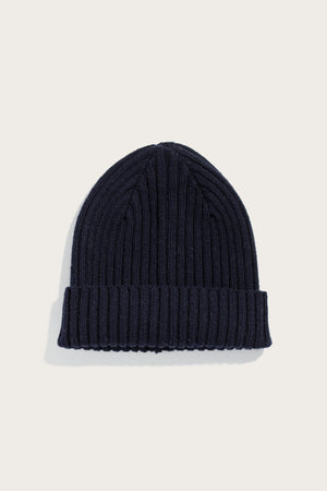 The Bridge & Burn Chunky Ribbed Beanie in Dark Navy, featuring a folded brim, is displayed on a plain light background.