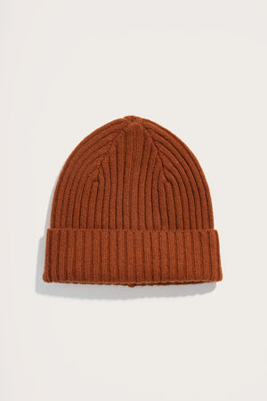The Chunky Ribbed Beanie in Sienna by Bridge & Burn features a rust tone, folded cuff, and soft knit texture, shown on a white background.