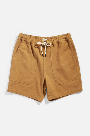 The Noah Short by Bridge & Burn in ochre features a relaxed pull-on style with elastic waistband, white drawstring, and two front pockets, crafted from a linen-cotton blend and shown flat on a white background.