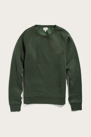 The Bridge & Burn Lincoln Crew Sweatshirt in Forest Night is a dark green, sustainable crewneck with long sleeves and ribbed cuffs, hem, and neckline, shown laid flat on a white background.