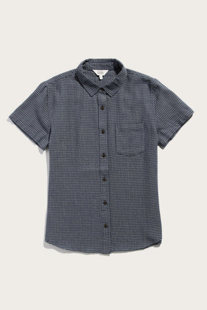 The Bridge & Burn Lana Shirt in Navy Grid is a relaxed fit, short sleeve button up with a collar and chest pocket, crafted from 100% cotton with a dark blue and black checkered pattern, shown laid flat on white.