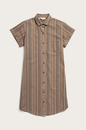 The Bridge & Burn Loren Shirt Dress / Multistripe is a short-sleeved, knee-length 100% cotton dress with brown, beige, and blue stripes, a collar, front buttons, and chest pocket from the Sustainable Series Collection. Laid flat on white.
