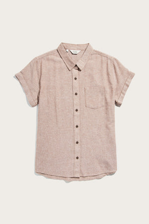 The Bridge & Burn Bea Shirt in Rust Chambray is a short-sleeve, light brown button-down made from recycled cotton with a single chest pocket, spread collar, and rolled cuffs, shown laid flat on a white background.