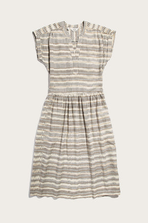 The Bridge & Burn Ira Dress in Mushroom Ikat Stripe is a short-sleeve, knee-length pullover with a V-neck, gathered waist, and neutral geometric stripes on lightweight fabric, shown laid flat on a white background.