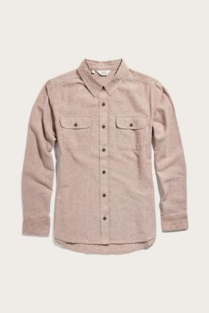 The Bridge & Burn Lenon Shirt in rust chambray is a relaxed-fit, long-sleeve button-up made from recycled cotton, featuring two chest pockets with buttoned flaps, shown on a plain white background.