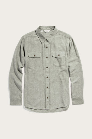 The Bridge & Burn Lenon Shirt in Sage Chambray is a long-sleeve, loose fit shirt with a collar and two flap chest pockets with button closures, shown laid flat on a white background.