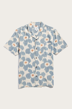 The Bridge & Burn Bodie Shirt in Polar Blossom is a relaxed fit summer button-up with short sleeves, a chest pocket, retro camp collar, and blue-and-white abstract floral print—shown laid flat on a white background.
