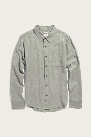 The Bridge & Burn Larson Shirt in Sage Chambray is a men’s classic fit casual button-up with a single chest pocket, dark buttons, and a classic collar. Shown laid flat on a plain white background.