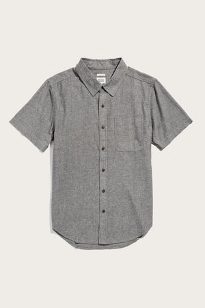 The Bridge & Burn Malcolm Shirt in Iron Chambray is a short-sleeve, collared button-up with a single chest pocket, made from recycled cotton and shown laid flat on a white background.