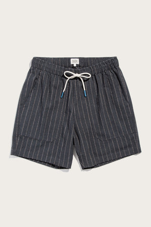 The Noah Short by Bridge & Burn in Charcoal Stripe features white vertical pinstripes, an elastic waist with a blue-tipped white drawstring, and two front pockets. Shown laid flat on a light background.