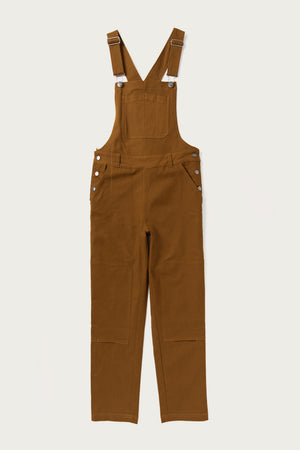 The Tobin Utility Overall by Bridge & Burn features brown cotton canvas, adjustable straps, a front chest pocket, side button closures, and straight legs. Shown flat on a white background for a classic workwear-inspired look.