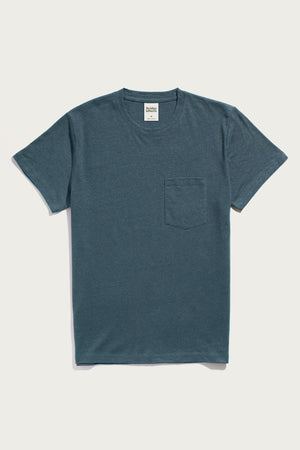 The Bridge & Burn Organic Hemp Pocket Tee in Storm Blue is a men's midweight, short-sleeve crew neck with a small chest pocket, shown laid flat on a white background.