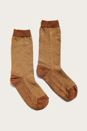 The Bridge & Burn Helix Sock in Ochre features cozy, textured brown crew socks with darker heels, toes, and cuffs—perfect for comfort and style in recycled materials.