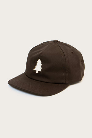 The Tree Cap / Espresso by Bridge & Burn is a black cotton twill hat featuring a white, stylized pine tree logo on the front, shown against a plain light background.