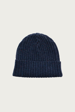 The Bridge & Burn Chunky Ribbed Beanie in Navy Donegal is crafted from sustainable wool with a folded brim, shown against a plain white background.