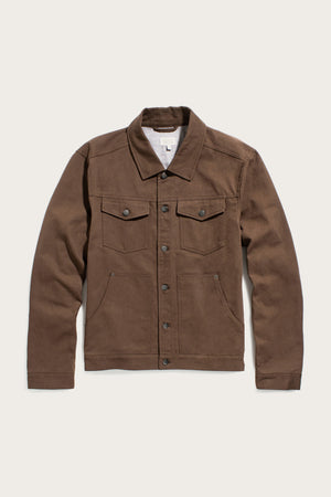 The Bridge & Burn Burl Trucker Jacket in Walnut, a brown denim jacket with front button closure, two chest flap pockets with buttons, and two side pockets, is laid flat on a light background.