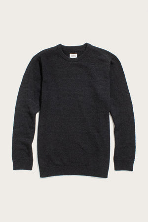 The Bridge & Burn Calder Sweater in Midnight is a long-sleeve crew neck sustainable knit, shown laid flat on a light background, with textured stitching and ribbed cuffs, collar, and hem.