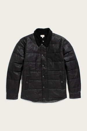 The Bridge & Burn Holman Quilted Jacket in black waxed canvas features a quilted design, button-up front, long sleeves, and a soft collar, shown on a light background.