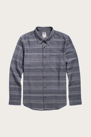 The Bridge & Burn Jude Shirt / Cascade Weave is a classic fit men's button-up with long sleeves, a collar, grey and blue stripes, chest pocket, and made from organic cotton. Laid flat on a white background.
