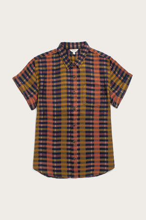 The Bridge & Burn Bea Shirt / Alpenglow Stripe is a short-sleeve, collared button down with a tailored fit, chest pocket, and striped plaid pattern in orange, navy blue, mustard yellow, and black. Shown laid flat on a light background.