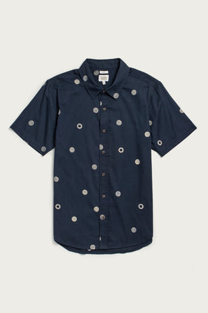 The Emerson Slim Shirt / Lunar Polka by Bridge & Burn is a navy blue short-sleeve, slim-fit button-up with a collar and evenly spaced white polka dots.