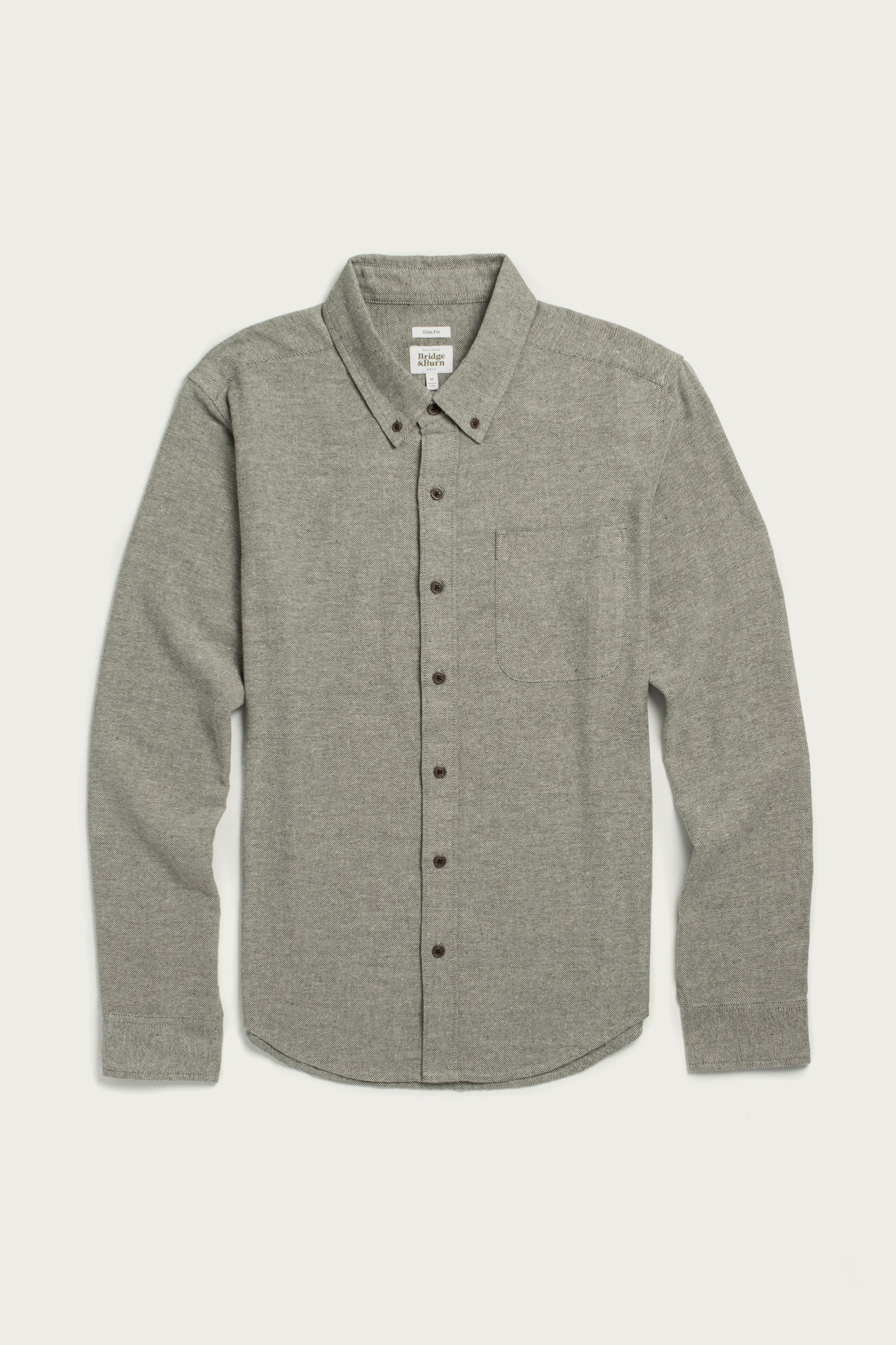 The Bridge & Burn Sutton Slim Shirt in olive twill features a minimalist design with a collar and chest pocket, crafted from recycled cotton, and is shown laid flat on a white background.