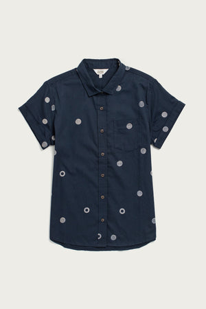 The Bridge & Burn Bea Shirt / Lunar Polka is a tailored-fit, short-sleeve collared shirt in navy organic cotton with a chest pocket and light blue polka dot pattern.