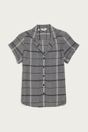The Bridge & Burn Innes Shirt in Overcast Grid is a relaxed fit, short-sleeve button-up made from recycled cotton with a gray base and white and black plaid, shown on a plain white background.