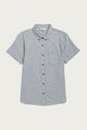 The Bridge & Burn Juniper Shirt in denim twill features short sleeves, a button-down collar, chest pocket, relaxed fit, and is crafted from recycled cotton. Shown here laid flat on a white background.