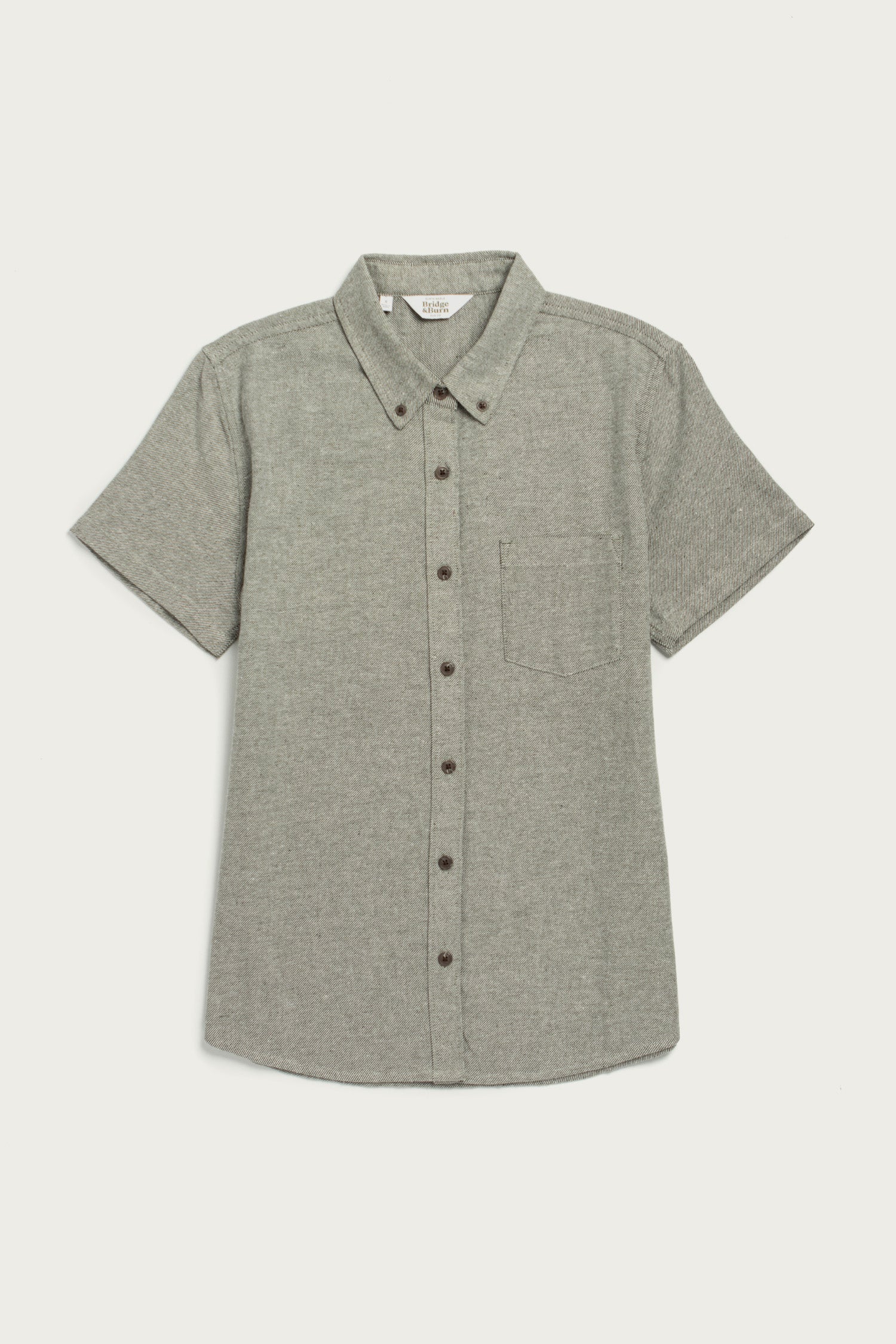 The Bridge & Burn Juniper Shirt in olive twill is a relaxed fit, short-sleeve button-down with a chest pocket and button-down collar, shown on a white background.
