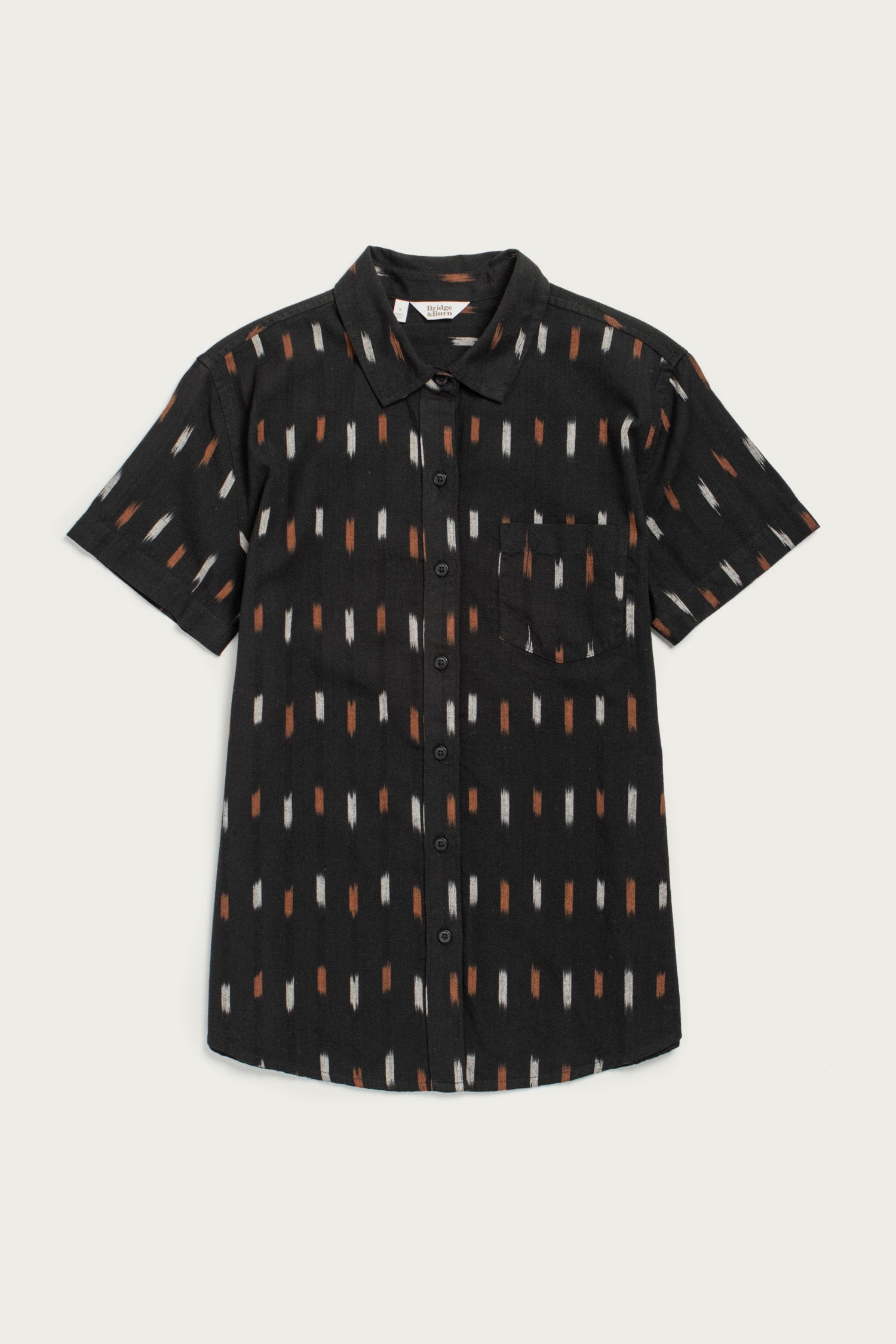 The Lana Shirt / Dotted Horizon by Bridge & Burn is a relaxed-fit, short sleeve black button-up with a collar, chest pocket, and vertical orange, brown, and white dashes, crafted from 100% cotton.