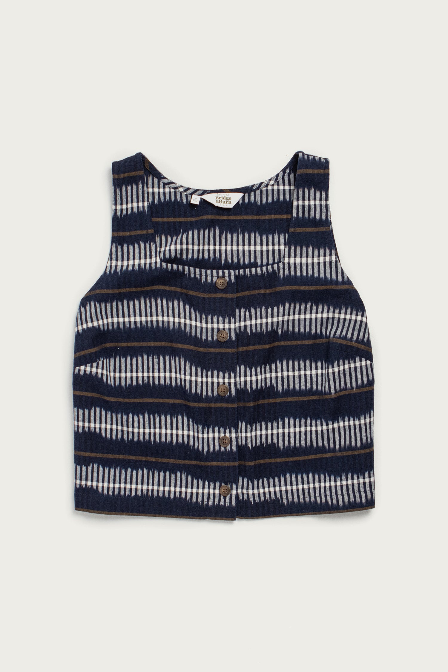 The Bridge & Burn Sadie Tank in Dusk Mirage is a sleeveless, boxy crop top with a button front and navy blue and white horizontal tie-dye stripes, shown flat on a white background.