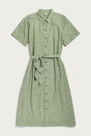 The Bridge & Burn Sylvie Dress in Teal Tide Waves is a light green, short-sleeve, collared shirtdress with a matching belt and subtle abstract print. Made from organic cotton, this relaxed midi dress is shown flat on a light background.