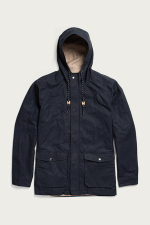 The Bridge & Burn Marshall Jacket in navy waxed canvas features a water-resistant shell, hood with drawstrings, front zipper and snap buttons, plus two large flap pockets—shown flat on a light background.