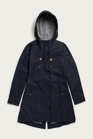 The Briar Jacket by Bridge & Burn is a navy waxed canvas parka featuring a hood, drawstrings with wooden toggles, front flap pockets with buttons, and an extended back hem—shown laid flat on a light background.