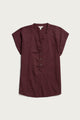 The Bridge & Burn Ladd Shirt in Burgundy is a short-sleeve, organic cotton blouse with a V-neckline, partial button placket, and relaxed fit, shown laid flat on a light background.