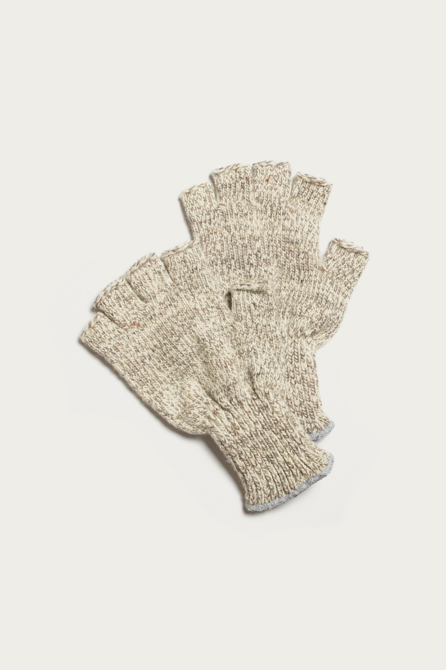 A pair of Bridge & Burn Ragg Wool Fingerless Gloves in Oatmeal is laid flat on a white background, with one glove slightly overlapping the other.